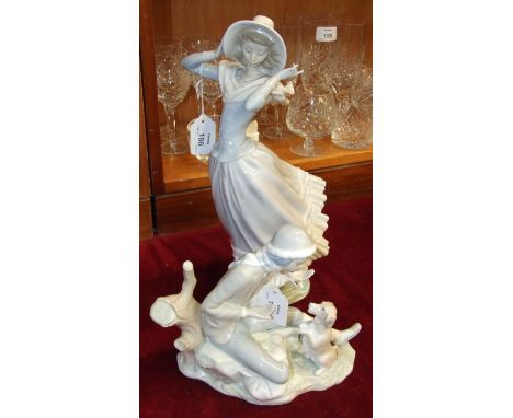 A Lladro figure of a young woman holding on to her bonnet in a breeze, 35cm high and a Nao figure of a dog begging in front o