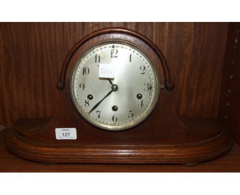 Jughans, Wurtemberg, an oak-cased shaped 'Napoleon's Hat' chiming mantel clock, 23cm high.