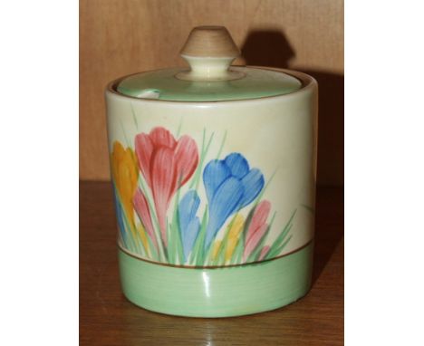 A Clarice Cliff preserve pot and cover decorated in the crocus pattern, factory mark and facsimile signature to base, 6.5cm d