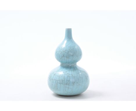 A Chinese monochrome celadon crackle-glazed double gourd vase, Qianlong mark, Republic, 20th C.H 32,5 cm