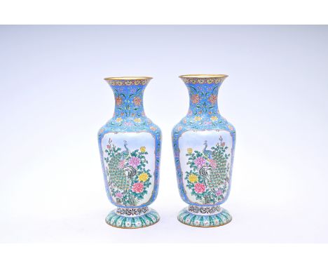 A pair of Chinese Canton enamel vases with phoenixes and a peacock among blossoming branches, 20th C.H 43,5 cm