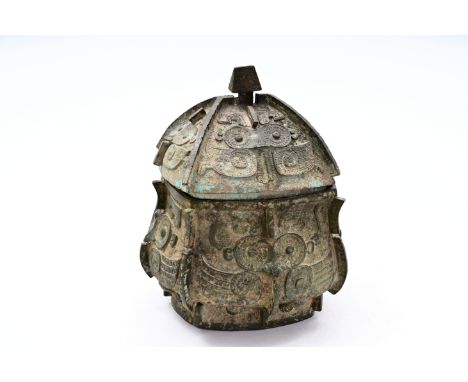 A large Chinese bronze ritual food vessel and cover, 'yi', probably early Western ZhouDim.: ca. 35 x 30 x 30 cmProvenance:- T