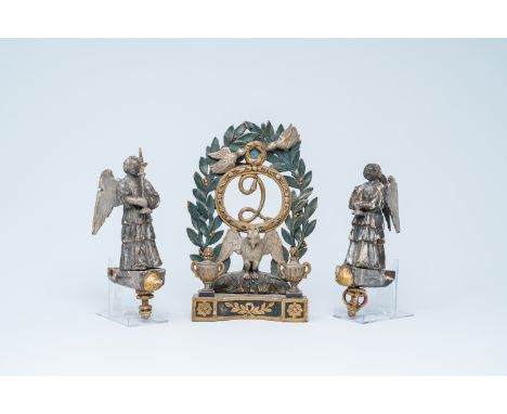 A carved and polychrome painted wood crown with a laurel wreath and a pair of gilt and silvered angels with a candlestick, 18