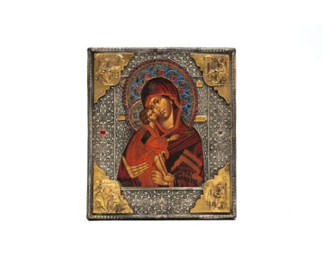 A Russian orthodox 'Vladimirskaya Mother of God' icon with partly enamelled silver oklad or riza, 19th/20th C.31 x 27 cm The 