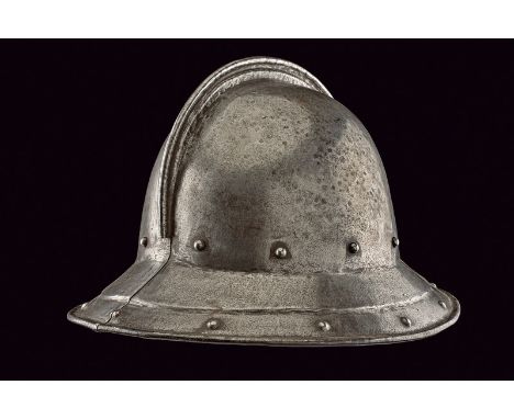 A pot helmet dating: 17th Century provenance: England Iron helmet in two parts, with sloping brim, recessed margin and hemmed