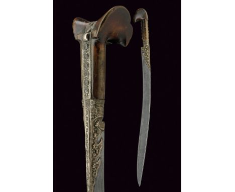 A yatagan dating: mid-19th Century provenance: Turkey Curved, single-edged blade with rear groove, richly engraved with inscr