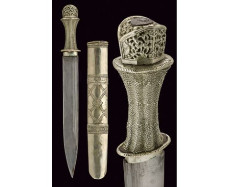 A fine silver mounted dagger dating: 19th Century provenance: Tibet Straight, single-edged blade with double rear groove; fin