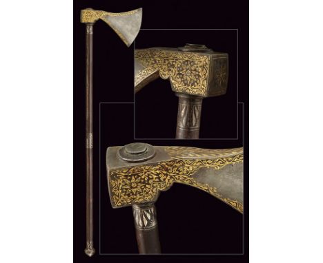 A battle axe dating: 19th Century provenance: Indopersia Round-edged head decorated with floral motifs in gold at the borders