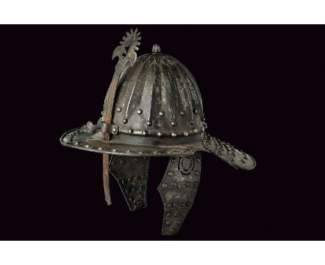 An officers lobster-tailed helmet dating: late 19th Century provenance: Northern Germany Hemispherical, iron skull with embos