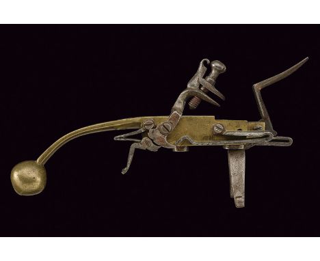 A flintlock lighter dating: 18th Century provenance: Europe Brass body, the back marked "FGAB" and engraved with dog and flor