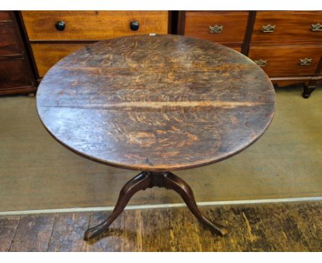 Georgian oak tilt top breakfast table on tripod turned column base, top 81cm diameter and 72cm high.