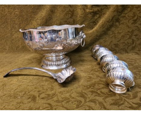 EPNS punch bowl, ladle and cups with embossed half fluting, floral sprays, lions mask and shaped gadrooned rims, associated E