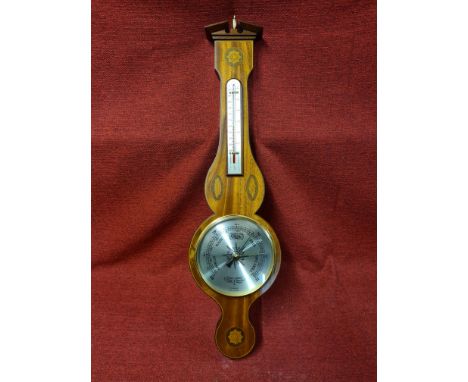 Modern Regency style mahogany inlaid wheel barometer by Comitti of London with decorative shell inlays and motifs.