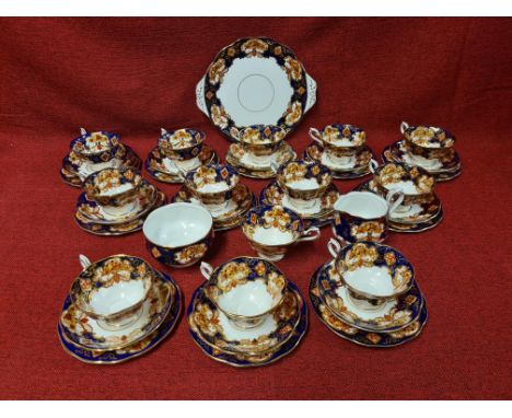 Royal Albert Heirloom Imari pattern china tea service comprising 12 trios, milk jug, sugar bowl, cake plate and spare cup.