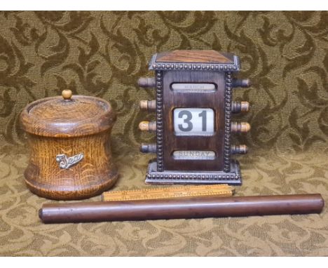 1930's oak desk calendar, oak tea caddy, folding Rabone ruler and mahogany roller ruler.
