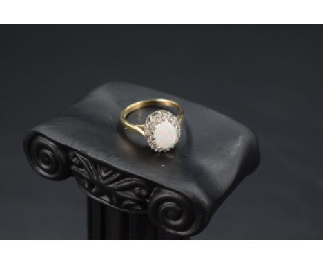 An opal and diamond chip cluster in a stepped claw mount on a 9ct gold loop, size J &amp; approx 2.7g