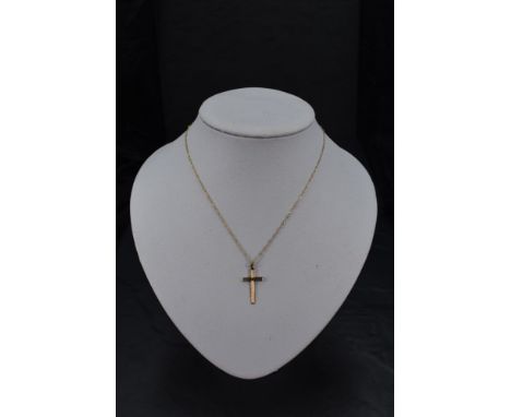 A 9ct gold cross having engine turned decoration on a fine 9ct gold rope chain, approx 16' &amp; 1.5g total