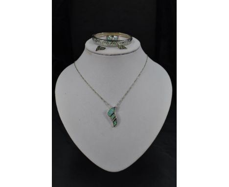 A silver and faux opal four piece jewellery suite comprising of pendant, earrings, ring and bangle, all having opal and cubic