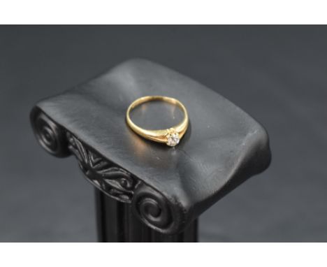 A diamond solitaire ring, approx 0.128ct in a claw set mount to split shoulders on an 18ct gold loop, size H &amp; approx 1.5