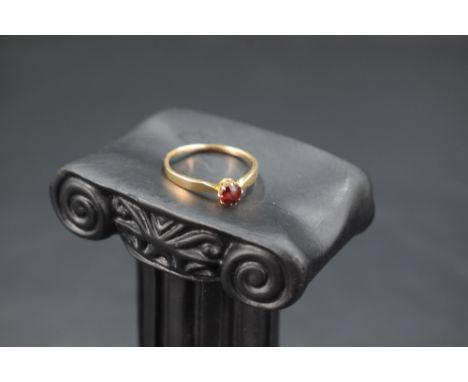 A garnet solitaire ring on a 15ct gold loop, size M &amp; approx 1.5g