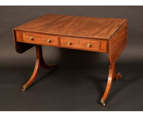 A Regency rosewood crossbanded mahogany sofa table, rounded rectangular top with fall leaves above a pair of frieze drawers, 