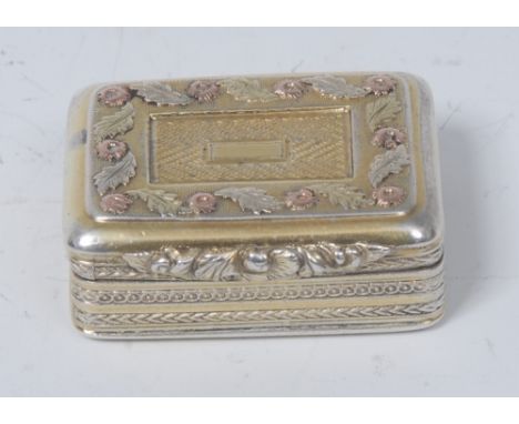 A George IV gold coloured metal mounted silver-gilt rounded rectangular vinaigrette, hinged cover outlined with a band of scr