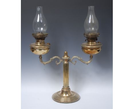 An early 20th century brass double oil lamp, Duplex type burners, acanthus grasped scrolling branches, fluted pillar, stepped