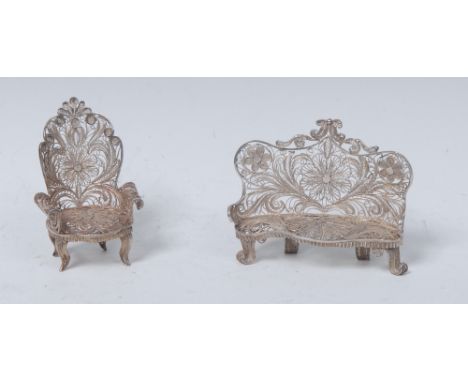 A Continental silver filigree miniature model, of a Louis XV sofa, 6.5cm wide; an armchair, similar (2)