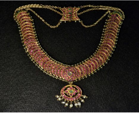  A Persian articulated ruby, spinel, emerald and seed pearl necklace, the oval pendant suspended with nine fresh water pearls