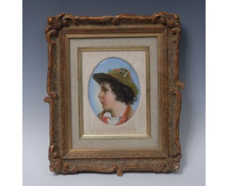 A 19th century Continental porcelain oval plaque, well painted with a portrait of a Bavarian boy, 12.5cm x 9.5cm, framed