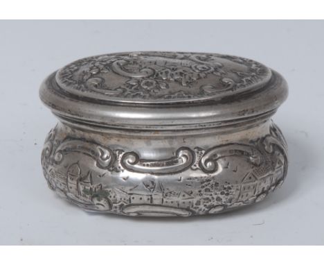 A Continental silver coloured metal oval snuff box, hinged cover, embossed with townscapes and C-scrolls, 6cm wide, marks to 