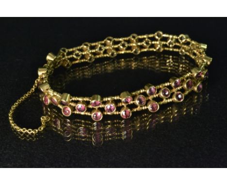  An 18ct gold  triple row amethyst fancy link bracelet, set with pale pink purple round cut amethyst each flanked and separat