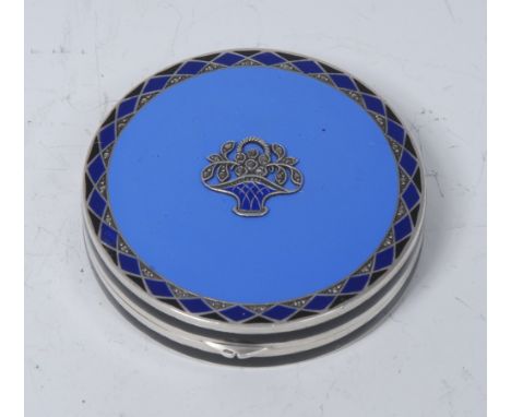 A German Art Deco silver and enamel circular rouge box, hinged cover applied with a paste-set basket of flowers, within a geo