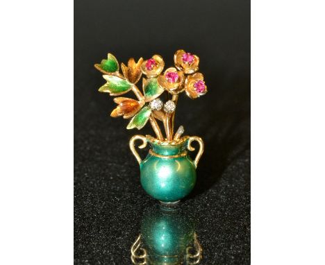  An enamelled flower vase brooch, the ruby and diamond set buds amongst enamelled leaves and green metallic enamel two handle