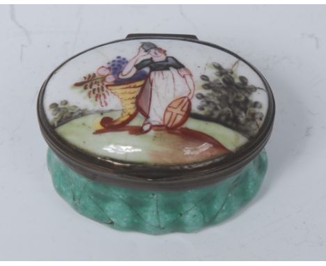 An 18th century Bilston enamel oval patch box, the cover with gilt standing by a fruiting cornucopia, green sides, 4cm wide, 