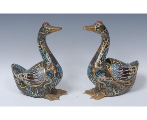 A pair of Chinese cloisonne enamel censers, as geese, each brightly decorated with scrolls, 23cm high