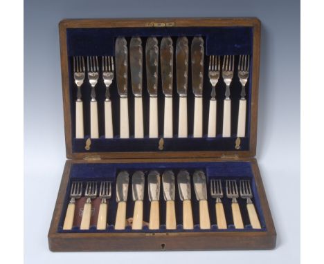 A George V silver fish service, comprising twelve pairs of knives and forks, the blades engraved with geometric bands and sty