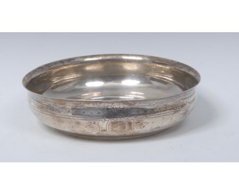 A 19th century Ottoman Turkish silver bowed circular bowl, engine turned, bright-cut and engraved with a vacant leafy cartouc