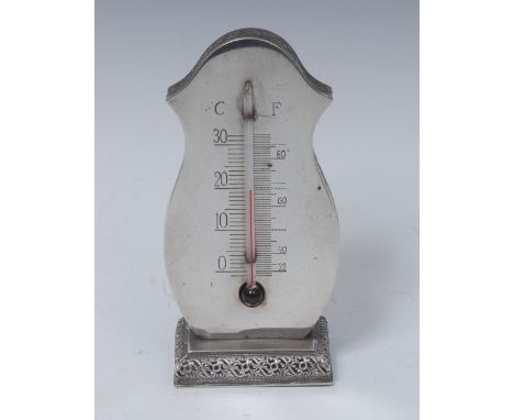 An early 20th century Swedish silver desk thermometer, engraved scale, rectangular base, pierced with borders of stylised lea