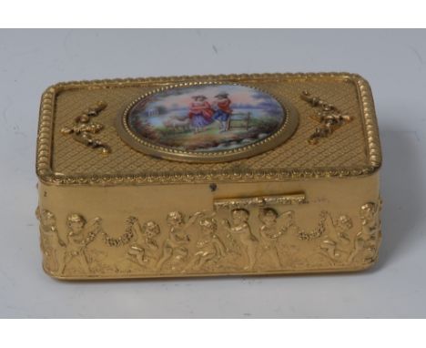 A Continental gilt metal and enamel singing bird box, hinged cover painted with a courting couple, enclosing a feathered occu