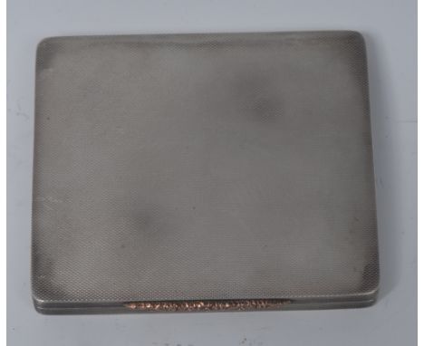 An Art Deco gold coloured metal mounted silver rounded rectangular snuff or cigarette box, engine turned overall, leafy scrol