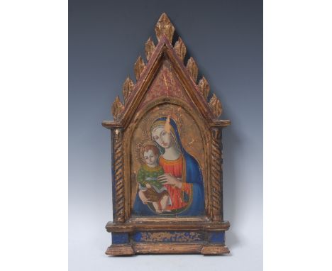 A 19th century icon, in the Gothic taste, depicting the Madonna and Child within an arch, the frame painted in tones of red, 