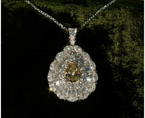 An impressive yellow and white diamond pear drop pendant necklace, set with a central fancy yellow pear diamond approx 1.01ct