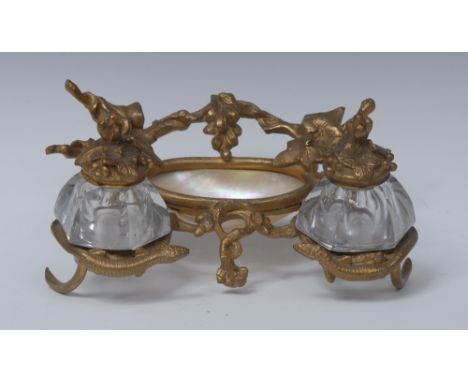 A 19th century ormolu and mother of pearl inkstand, cast with serpents and fruiting vine, central recess flanked by a pair of