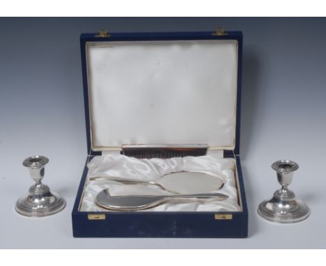 A pair of Elizabeth II silver candlesticks, bell shaped sconces, laurel borders, spreading circular bases, 10cm high, Adie Br