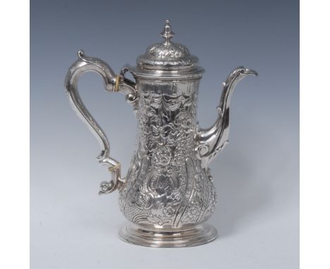 A George II silver baluster coffee pot, hinged domed cover with knop finial, profusely chased with flowers, C-scrolls, scales