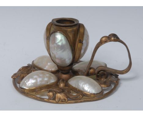 A 19th century French gilt metal and mother of pearl chamberstick, embossed with scrolling leaves and set with half-shells, l