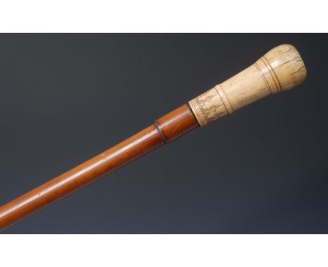 A Queen Anne ivory mounted gentleman's walking cane, the turned pommel decorated with bands and pendants of roundels, traces 