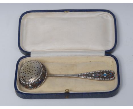 A late 19th/early 20th century Russian silver and cloisonne enamel sifter spoon, brightly decorated in polychrome with stylis