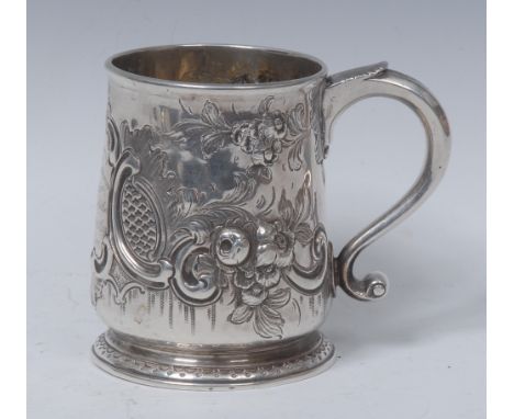 A George II silver half pint mug, chased with C-scrolls, scales and flowers, acanthus capped scroll handle, skirted base, 9.5